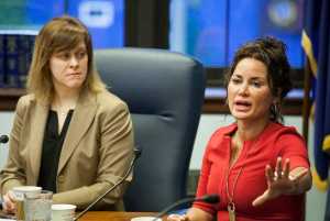 Sen. Mia Costello, R-Anchorage, left, watches as colleague Sen. Lesil McGuire, right, discusses the state's tax credit program for oil companies during a Senate Majority news conference on Monday, April 11, 2016, in Juneau, Alaska. A planned Sunday vote on a bill that is designed to gradually reduce the $825 million in credits to companies with no tax liabilities stalled on the House floor. Republican House majority members have delayed committee meetings Monday as they meet to hammer out a consensus on House Bill 247. (AP Photo/Rashah McChesney)