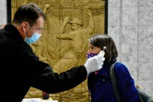 Rep. Jennifer Johnston, R-Anchorage, gets her temperature taken as she enters the Alaska State Capitol on Monday, May 18, 2020. (Peter Segall / Juneau Empire File)