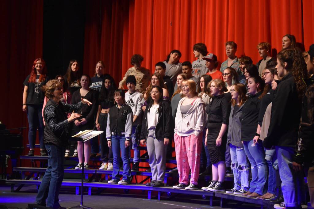 Audra Calloway directs the Soldotna High School Choir in a rehersal on Oct. 11, 2022, at Soldotna High School in Soldotna, Alaska. (Jake Dye/Peninsula Clarion)