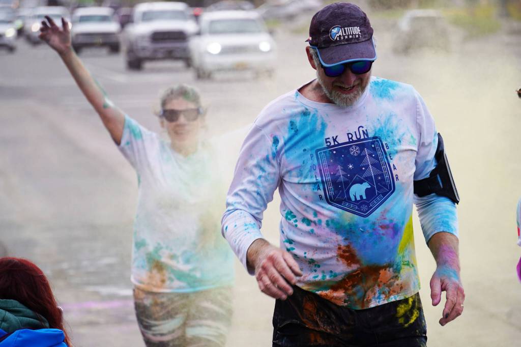 Participants are covered with colored powder during a color run held as part of during the Levitt AMP Soldotna Music Series on Wednesday, June 7, 2023, along the Sterling Highway in Soldotna, Alaska. (Jake Dye/Peninsula Clarion)