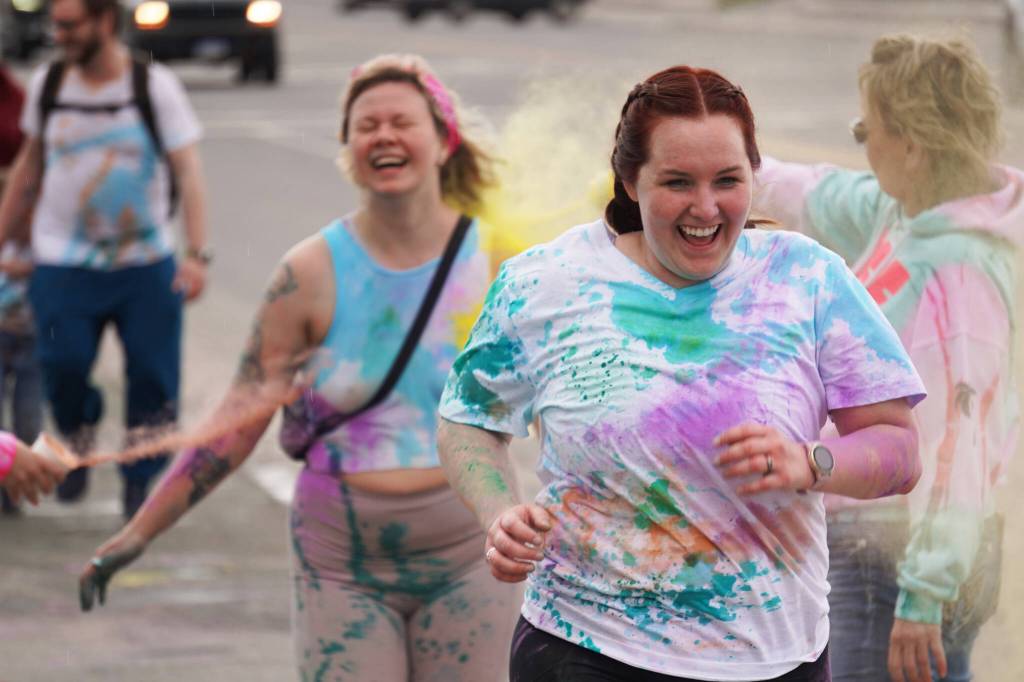Participants are covered with colored powder during a color run held as part of during the Levitt AMP Soldotna Music Series on Wednesday, June 7, 2023, along the Sterling Highway in Soldotna, Alaska. (Jake Dye/Peninsula Clarion)