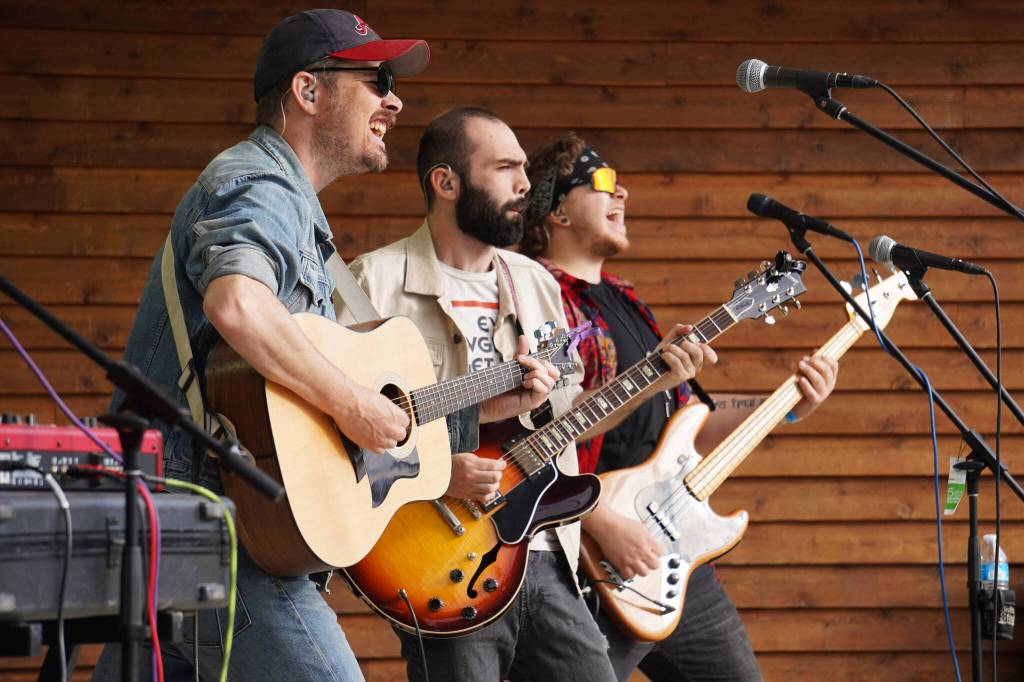 Blackwater Railroad Companys Tyson Davis, Matt Faubion and Ben Sayers perform during the Levitt AMP Soldotna Music Series on Wednesday, June 7, 2023, at Soldotna Creek Park in Soldotna, Alaska. (Jake Dye/Peninsula Clarion)