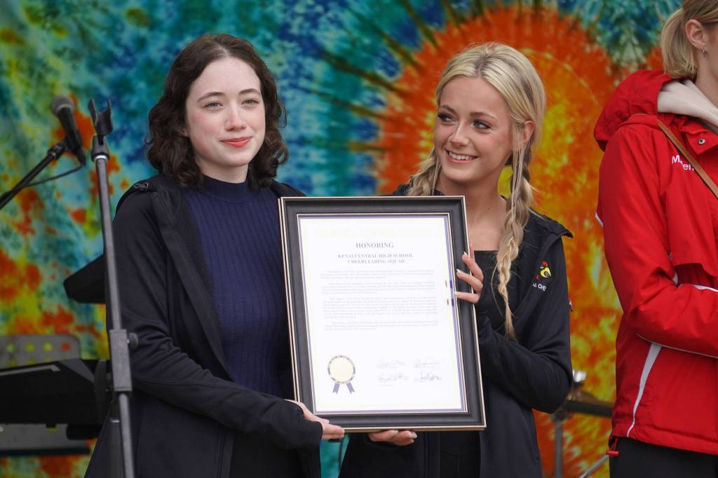 Members of the Kenai Central High School cheerleading team are awarded a legislative citation ahead of the start of the Soldotna Music Series performance on Wednesday, June 21, 2023, at Soldotna Creek Park in Soldotna, Alaska. (Jake Dye/Peninsula Clarion)