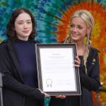 Members of the Kenai Central High School cheerleading team are awarded a legislative citation ahead of the start of the Soldotna Music Series performance on Wednesday, June 21, 2023, at Soldotna Creek Park in Soldotna, Alaska. (Jake Dye/Peninsula Clarion)