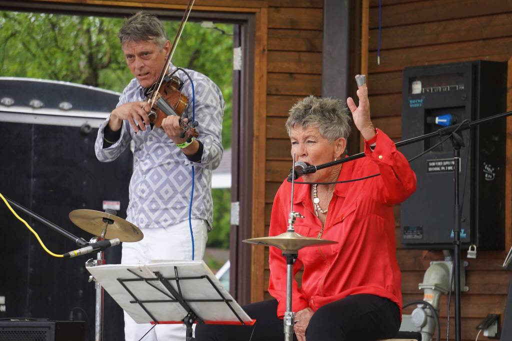 Rob Paulus and Connie Brannock, both part of Connie Brannocks Tiny House of Funk, perform during the Soldotna Music Series at Soldotna Creek Park in Soldotna, Alaska, on Wednesday, June 21, 2023. (Jake Dye/Peninsula Clarion)