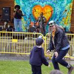 Attendees dance before the stage as Wasabi Black performs during the Soldotna Music Series at Soldotna Creek Park in Soldotna, Alaska, on Wednesday, June 21, 2023. (Jake Dye/Peninsula Clarion)