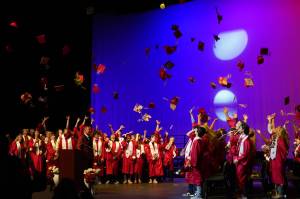 Students of Kenai Central High School celebrate at the end of their graduation ceremony in the schools auditorium in Kenai, Alaska, on Monday, May 13, 2024. (Jake Dye/Peninsula Clarion)