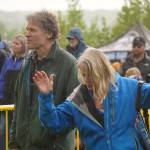 Attendees dance in the rain as Hope Social Club headlines the opening night of the 2024 Levitt AMP Soldotna Music Series at Soldotna Creek Park in Soldotna, Alaska, on Wednesday, June 5, 2024. (Jake Dye/Peninsula Clarion)