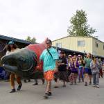 People parade through the Salmon Causeway at Salmonfest in Ninilchik, Alaska, on Saturday, Aug. 3, 2024. (Jake Dye/Peninsula Clarion)