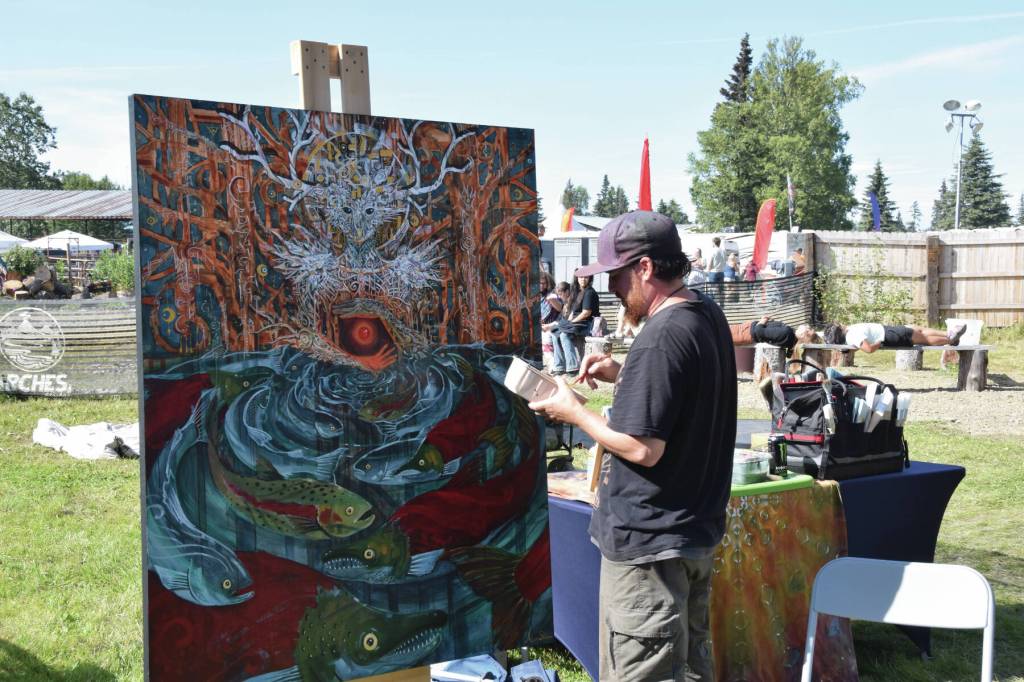Anchorage-based artist Adam Shea paints live at Salmonfest next to the River Stage Amphitheater on Sunday, Aug. 4, 2024, in Ninilchik, Alaska. (Delcenia Cosman/Homer News)