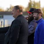 Colony High School marching band director Jamin Burton; Kenai Central High School band director Christian Stephanos; and Soldotna High School band director Mark Jurek watch their bands together play Chappell Roans HOT TO GO! during the Kenai Marching Showcase at Ed Hollier Field in Kenai, Alaska, on Saturday, Sept. 21, 2024. (Jake Dye/Peninsula Clarion)