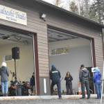 Jenny Neyman, administrative coordinator of the Tsalteshi Trails Association, speaks during a winter kick-off and open house event to celebrate a new maintenance shed Saturday, Oct. 12, 2024, just outside of Soldotna, Alaska. (Photo by Jeff Helminiak/Peninsula Clarion)