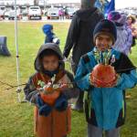 Two young contestants hold their pumpkins at the City of Kenais 9th annual Fall Pumpkin Festival in Kenai, Alaska, on Saturday, Oct. 12, 2024. (Photo by Jonas Oyoumick/Peninsula Clarion)
