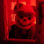 One frightening figure peers out from a doll house in the Haunted Chamber at the Kenai Chamber of Commerce and Visitor Center in Kenai, Alaska, on Friday, Oct. 18, 2024. (Jake Dye/Peninsula Clarion)