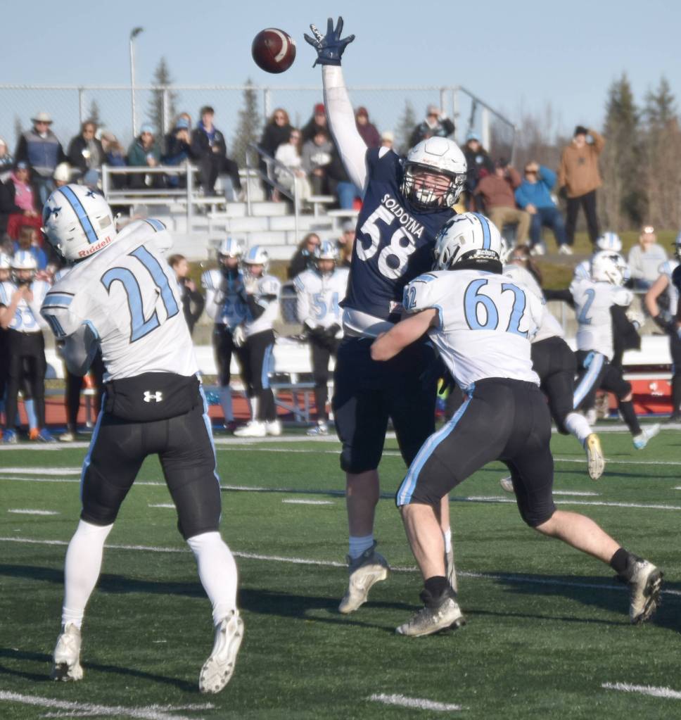 Chugiaks Kaleb Worland has to deal with pressure from Soldotnas Theo Huff in the Division II semifinal Saturday, Oct. 19, 2024, at Justin Maile Field at Soldotna High School in Soldotna, Alaska. (Photo by Jeff Helminiak/Peninsula Clarion)