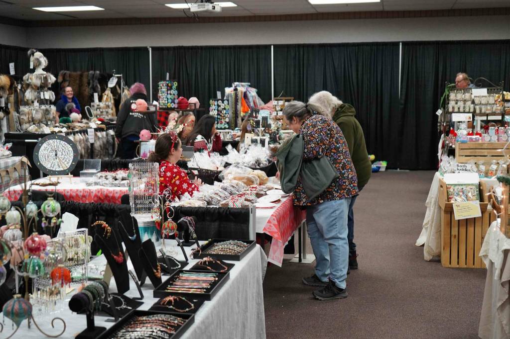 Shoppers browse wares at the 33rd Annual Holiday Bazaar at the Soldotna Regional Sports Complex in Soldotna, Alaska, on Friday, Nov. 22, 2024. (Jonas Oyoumick/Peninsula Clarion)