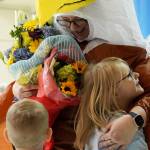 Students embrace Aubrie Ellis after she was named National Outstanding Assistant Principal of 2025 by the Alaska Association of Elementary School Principals at Mountain View Elementary School in Kenai, Alaska, on Friday, Jan. 10, 2025. (Jake Dye/Peninsula Clarion)