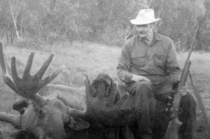 Clarence Hiram Poopdeck Platt sits atop a recent moose kill. (Photo from In Those Days: Alaska Pioneers of the Lower Kenai Peninsula, Vol. II)