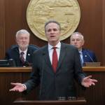 Gov. Mike Dunleavy delivers his State of the State speech at the Alaska State Capitol on Tuesday, Jan. 28, 2025, with Senate President Gary Stevens, at left, and House Speaker Bryce Edgmon, at right, in the background. (Klas Stolpe/Juneau Empire)