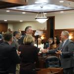 Republican Gov. Mike Dunleavy, center, shakes hands with Senate Minority Leader Mike Shower, a Wasilla Republican, right, before delivering his State of the State speech Tuesday, Jan. 28, 2025, at the Alaska State Capitol. (Klas Stolpe/Juneau Empire)