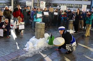 Jamiann Seiltin Hasselquist asks participants to kneel as a gesture to stay grounded in the community during a protest in front of the Alaska State Capitol on Wednesday focused on President Donald Trumps actions since the beginning of his second term. (Mark Sabbatini / Juneau Empire)