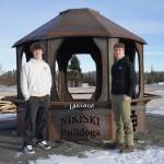 Gavin Ley and Noah Douglas stand with a firepit they designed and installed with other students in the career and technical education courses at Nikiski Middle/High School in Nikiski, Alaska, on Tuesday, Feb. 11, 2025. (Jake Dye/Peninsula Clarion)
