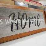 Signs crafted of wood and metal by Nikiski Middle/High School students are displayed during a meeting of the Kenai Peninsula Borough School Districts Board of Education in Soldotna, Alaska, on Monday, Feb. 3, 2025. (Jake Dye/Peninsula Clarion)