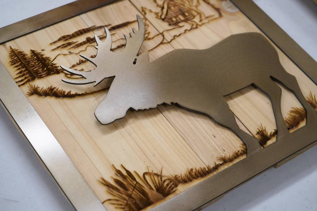 Signs crafted of wood and metal by Nikiski Middle/High School students are displayed during a meeting of the Kenai Peninsula Borough School Districts Board of Education in Soldotna, Alaska, on Monday, Feb. 3, 2025. (Jake Dye/Peninsula Clarion)