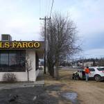 A 2015 Ford Explorer that police say was stolen from the Kenai Chamber of Commerce and Visitor Center before crashing into a tree near Wells Fargo Bank is loaded onto a tow truck in Kenai, Alaska, on Tuesday, Feb. 18, 2025. (Jake Dye/Peninsula Clarion)