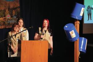 Girl Scout Troop 210, which includes Caitlyn Eskelin, Emma Hindman, Kadie Newkirk and Lyberty Stockman, present their Bucket Trees to a panel of judges in the 34th Annual Caring for the Kenai Competition at Kenai Central High School in Kenai, Alaska, on Thursday, April 18, 2024. (Jake Dye/Peninsula Clarion)