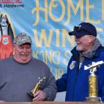 John Raymond accepts his tenth place trophy during the 2025 Homer Winter King Salmon Tournament on Saturday, March 22, 2025, at the Deep Water Dock on the Homer Spit in Homer, Alaska. (Delcenia Cosman/Homer News)