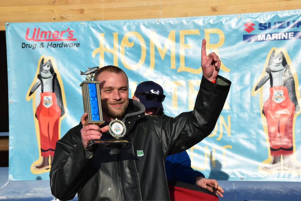 Tournament champion Zach Weimann holds up his first-place trophy during the 2025 Homer Winter King Salmon Tournament on Saturday, March 22, 2025, at the Deep Water Dock on the Homer Spit in Homer, Alaska. (Delcenia Cosman/Homer News)