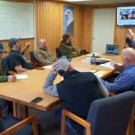 Monte Roberts, left, and Greg Brush, right, raise their hands during an emergency meeting of the Kenai River Special Management Area Advisory Boards guide committee at the Kenai Peninsula Region Office of Alaska State Parks near Soldotna, Alaska, on Feb. 25, 2025. (Jake Dye/Peninsula Clarion)