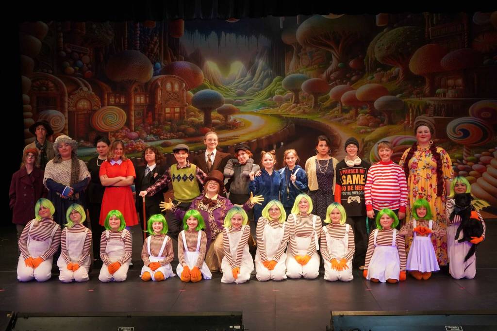 The cast of Seward High School Theatre Collectives Charlie and the Chocolate Factory appear for a photo on Thursday, April 3, 2025. (Jake Dye/Peninsula Clarion)