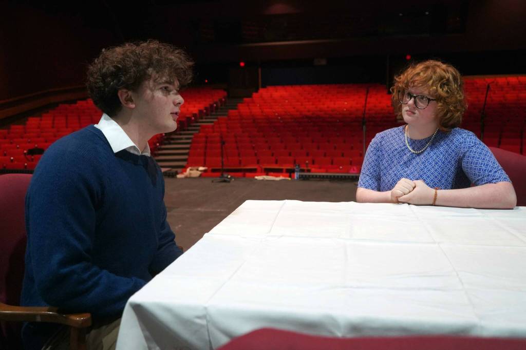 Elias Bouschor and Ada Bon rehearse Our Town in the Soldotna High School Auditorium in Soldotna, Alaska, on Friday, April 18, 2025. (Jake Dye/Peninsula Clarion)