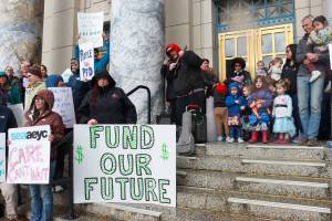 Geoff Kirsch and students from Sayéik Gastineau Community School sing during a rally for early education funding at the Alaska State Capitol on Tuesday, April 29, 2025. (Jasz Garrett / Juneau Empire)