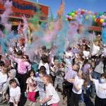 Students throw brightly hued powder into the air during a color run at Kaleidoscope School of Arts and Science in Kenai, Alaska, on Saturday, May 3, 2025. (Jake Dye/Peninsula Clarion)