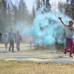 Students are covered in brightly hued powder during a color run at Kaleidoscope School of Arts and Science in Kenai, Alaska, on Saturday, May 3, 2025. (Jake Dye/Peninsula Clarion)