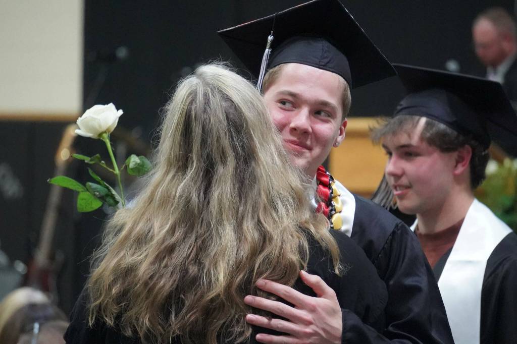 Nikiski graduates bring roses to their supporters during a commencement ceremony at Nikiski/Middle High School in Nikiski, Alaska, on Monday, May 19, 2025. (Jake Dye/Peninsula Clarion)