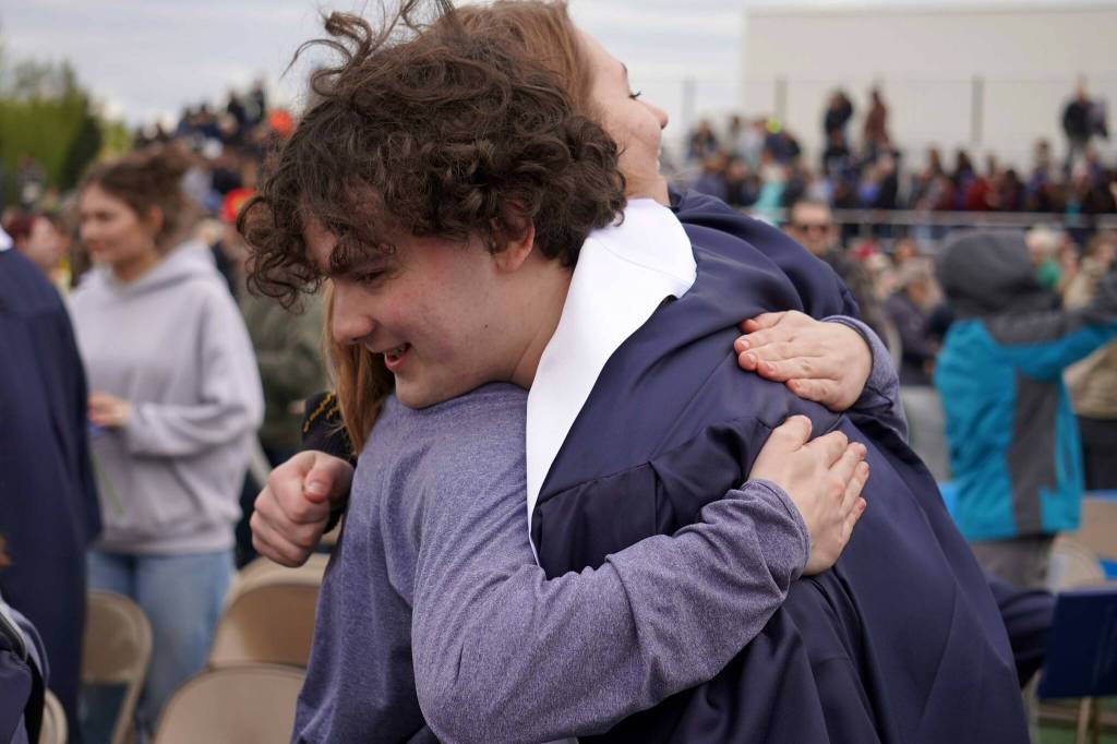 Elias Bouschor, a graduates of Soldotna High School, celebrates after receiving his diploma on the schools football field in Soldotna, Alaska, on Wednesday, May 21, 2025. (Jake Dye/Peninsula Clarion)
