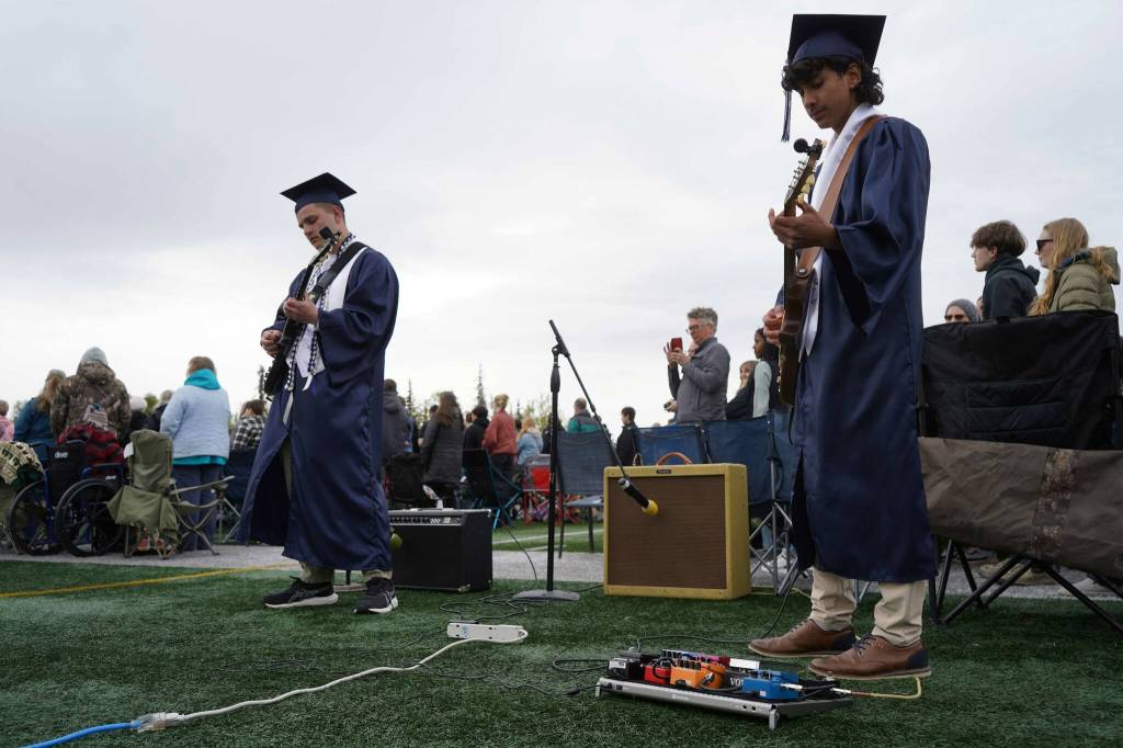 Sam Klein and Harold Rudstrom perform the national anthem during Soldotna High Schools graduation ceremony on the schools football field in Soldotna, Alaska, on Wednesday, May 21, 2025. (Jake Dye/Peninsula Clarion)