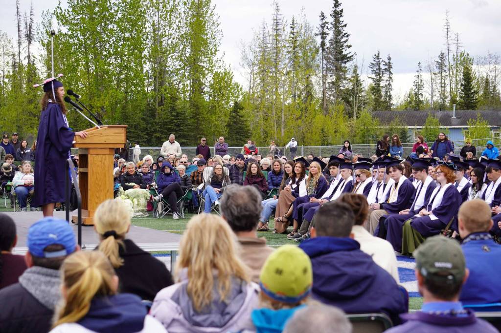 Annie Burns, senior class vice president at Soldotna High School, introduces the commencement speaker during a graduation ceremony on the schools football field in Soldotna, Alaska, on Wednesday, May 21, 2025. (Jake Dye/Peninsula Clarion)
