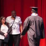Elijah Lee walks to receive his diploma from his parents during a graduation ceremony for Connections Homeschool in Soldotna, Alaska, on Thursday, May 22, 2025. (Jake Dye/Peninsula Clarion)