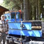 Larry Bernbeck poses for a photo with Tugster on Thursday, June 5, 2025 in Homer, Alaska. (Chloe Pleznac/Homer News)