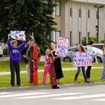 Swimmers and parents protest the proposed closure of Kenai Peninsula Borough School District pools outside of the Kenai Peninsula Borough Administration Building in Soldotna on Thursday. (Jake Dye/Peninsula Clarion)