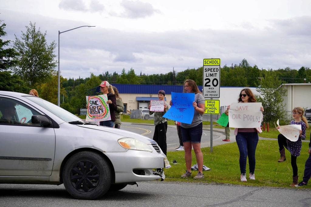 Swimmers and parents protest the proposed closure of Kenai Peninsula Borough School District pools outside of the Kenai Peninsula Borough Administration Building in Soldotna, Alaska, on Thursday, June 26, 2025. (Jake Dye/Peninsula Clarion)