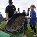 Volunteers haul dirt at Erik Hansen Scout Park in Kenai, Alaska, on Wednesday, June 25, 2025. (Jake Dye/Peninsula Clarion)
