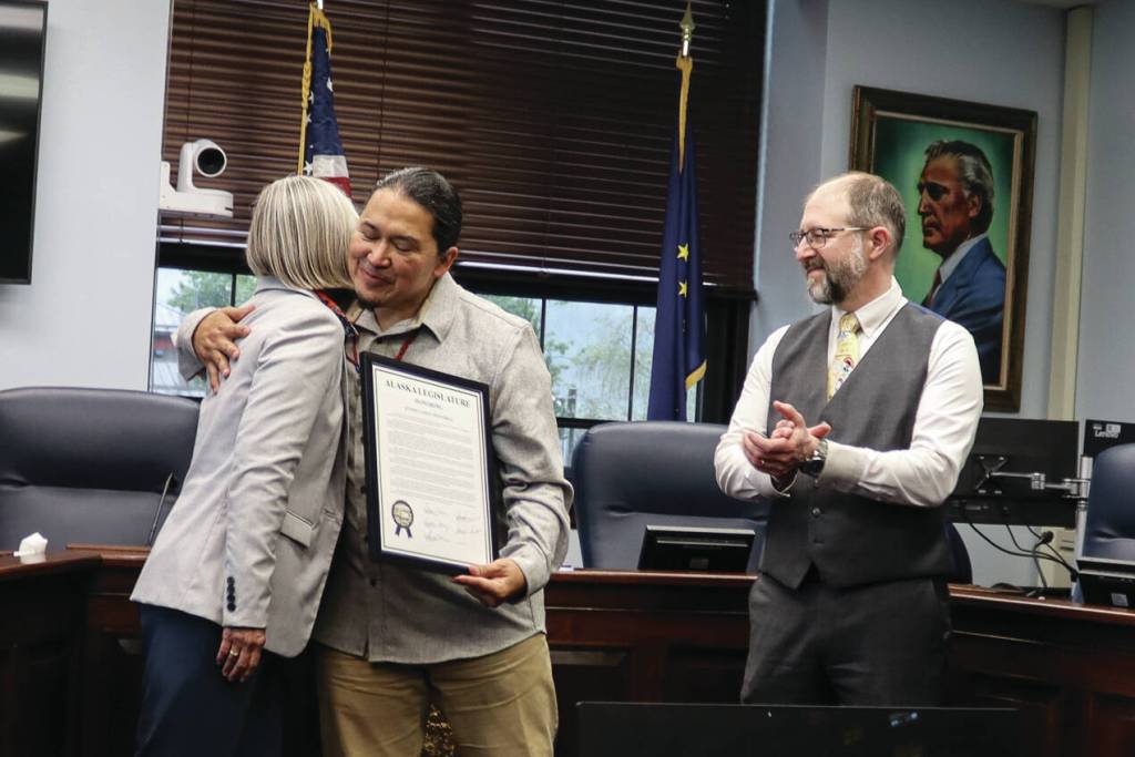 X̱unei Lance Twitchell receives his legislative citation from Rep. Andi Story, D Juneau, at a ceremony at the Alaska State Capitol on Saturday. (Ellie Ruel / Juneau Empire)