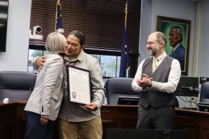 X̱unei Lance Twitchell receives his legislative citation from Rep. Andi Story, D Juneau, at a ceremony at the Alaska State Capitol on Saturday. (Ellie Ruel / Juneau Empire)