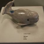A clay beluga sits on pedestal the Kenai Potters Guild exhibit, River, hosted by the Kenai Art Center. (Jonas Oyoumick/Peninsula Clarion)